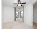 Bright bedroom with carpet flooring, ceiling fan, and window coverings at 19261 Isadora St, Venice, FL 34293