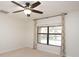 Bedroom with large window offering pool view and ceiling fan at 19261 Isadora St, Venice, FL 34293