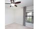 Bright bedroom with neutral walls, ceiling fan, and window with curtains at 19261 Isadora St, Venice, FL 34293