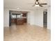 Open living area with tile flooring, kitchen views, and ceiling fan at 19261 Isadora St, Venice, FL 34293