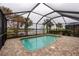 Screened-in pool with brick patio; overlooks canal at 19261 Isadora St, Venice, FL 34293