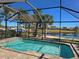 Screened-in pool with lake view at 19261 Isadora St, Venice, FL 34293