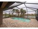 Screened-in pool and patio area with lake view at 19261 Isadora St, Venice, FL 34293