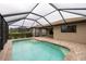 Screened-in pool with brick patio and house view at 19261 Isadora St, Venice, FL 34293