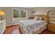 Bright bedroom with wood floors and window view at 2047 Canal Dr # L6, Bradenton, FL 34207