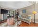 Living room with hardwood floors, wicker furniture, and sliding glass door at 2047 Canal Dr # L6, Bradenton, FL 34207