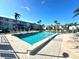 Community pool with plenty of lounge chairs at 2047 Canal Dr # L6, Bradenton, FL 34207