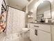 Bathroom with polka dot shower curtain, white vanity, and granite countertop at 22490 Madelyn Ave, Port Charlotte, FL 33954