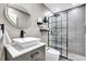 Modern bathroom with a sleek white sink, frameless shower, and floating shelves at 2341 Spring Oaks Cir, Sarasota, FL 34234