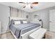 Bright bedroom featuring a king-size bed, white bench, and gray bedding at 2341 Spring Oaks Cir, Sarasota, FL 34234