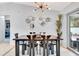 Modern dining room with black table, six chairs, and unique wall decor at 2341 Spring Oaks Cir, Sarasota, FL 34234