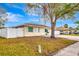 Tan house with white trim, white fence, and driveway at 2341 Spring Oaks Cir, Sarasota, FL 34234