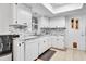 White kitchen with marble countertops and stainless steel appliances at 2341 Spring Oaks Cir, Sarasota, FL 34234