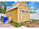 Large tan shed with double doors in backyard at 2341 Spring Oaks Cir, Sarasota, FL 34234