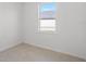 Bright bedroom with light flooring and a large window at 25109 Macapa Dr, Punta Gorda, FL 33983