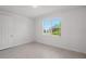 Well-lit bedroom with window and tile floor at 25109 Macapa Dr, Punta Gorda, FL 33983