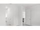 Bright hallway with white walls and light wood floors at 25109 Macapa Dr, Punta Gorda, FL 33983