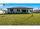 Exterior view of the house showcasing the backyard and landscaping at 25109 Macapa Dr, Punta Gorda, FL 33983