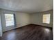 Bedroom with dark wood-look flooring and window at 2599 Woodgate Ln # K7, Sarasota, FL 34231