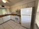 Condo kitchen with white cabinets and appliances at 2599 Woodgate Ln # K7, Sarasota, FL 34231