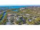 An aerial view showcasing a waterfront community and a homesite with mature trees at 32 Bayhead Ln, Osprey, FL 34229