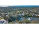 Aerial view of a home by the lake and ocean in a residential area at 32 Bayhead Ln, Osprey, FL 34229