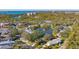 An aerial view showcasing a waterfront community and a homesite with mature trees at 32 Bayhead Ln, Osprey, FL 34229