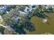 Aerial view of house near a lake in a residential neighborhood at 32 Bayhead Ln, Osprey, FL 34229