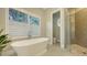 Luxurious bathroom with soaking tub, walk-in shower, and modern fixtures at 32 Bayhead Ln, Osprey, FL 34229