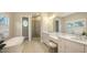 Spa-like bathroom with soaking tub, double vanity, and glass shower at 32 Bayhead Ln, Osprey, FL 34229