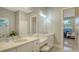 Elegant bathroom with double vanity, quartz countertop and view to bedroom at 32 Bayhead Ln, Osprey, FL 34229