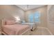 Cozy bedroom with twin beds, window with plantation shutters at 32 Bayhead Ln, Osprey, FL 34229