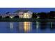 Elegant clubhouse at night reflecting on water at 32 Bayhead Ln, Osprey, FL 34229