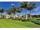 Luxury clubhouse with palm trees and manicured lawns at 32 Bayhead Ln, Osprey, FL 34229