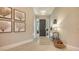 Bright entry with tile flooring, console table, and elegant wall art at 32 Bayhead Ln, Osprey, FL 34229