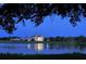 Elegant waterfront home at dusk, reflecting in the water at 32 Bayhead Ln, Osprey, FL 34229