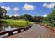 Wooden bridge crossing a pond near a golf course at 32 Bayhead Ln, Osprey, FL 34229