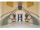 Elegant double staircase in a marble foyer at 32 Bayhead Ln, Osprey, FL 34229