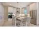 Modern white kitchen with stainless steel appliances and island at 32 Bayhead Ln, Osprey, FL 34229