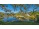 Scenic view of a tranquil lake with lush landscaping and a home in the background at 32 Bayhead Ln, Osprey, FL 34229