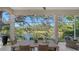 Enjoy the lake view from this screened porch with dining area at 32 Bayhead Ln, Osprey, FL 34229