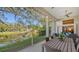 Spacious screened-in porch with seating and lake view at 32 Bayhead Ln, Osprey, FL 34229