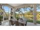 Relaxing screened porch with patio furniture overlooking a lake at 32 Bayhead Ln, Osprey, FL 34229