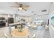 Open floor plan with kitchen island, dining table, and white furniture and decor in the living room at 320 Whitfield Ave, Sarasota, FL 34243