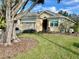 Tan house with gray roof, two-car garage, and lush landscaping at 3312 92Nd E Ave, Parrish, FL 34219