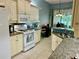 Spacious kitchen featuring white cabinets, granite countertops, and tile backsplash at 3312 92Nd E Ave, Parrish, FL 34219