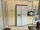 Kitchen with white refrigerator, ample cabinetry and granite countertops at 3312 92Nd E Ave, Parrish, FL 34219