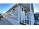 Side view of the mobile home showing gray siding and a covered entryway at 3333 26Th E Ave # 1219, Bradenton, FL 34208