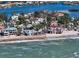 Beachfront home with a red tile roof and palm trees at 3625 Casey Key Rd, Nokomis, FL 34275