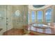 Spa-like bathroom featuring a large soaking tub and walk-in shower, with ocean views at 3625 Casey Key Rd, Nokomis, FL 34275